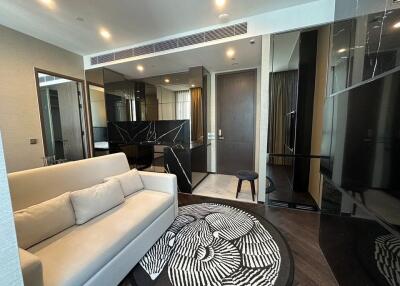 Modern living area with sofa, decorative rug, and stylish furnishings