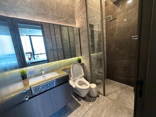 Modern bathroom with glass shower and large mirror