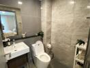 Modern bathroom with a toilet, sink, and wall-mounted mirror