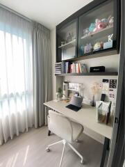 A modern home office with a desk, chair, and shelves