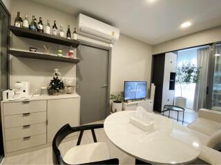 Modern living area with dining table and television