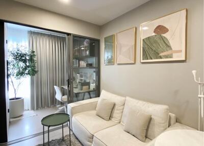 Modern living area with a comfortable sofa and artworks on the wall.