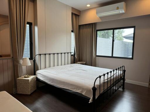 Spacious bedroom with large windows and ample natural light