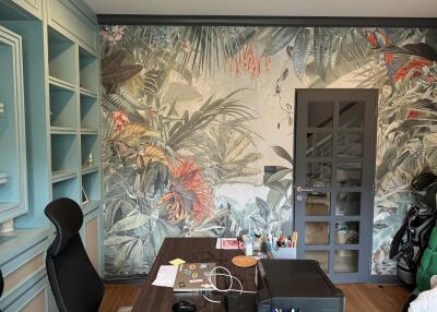 Home office with tropical wallpaper and desk