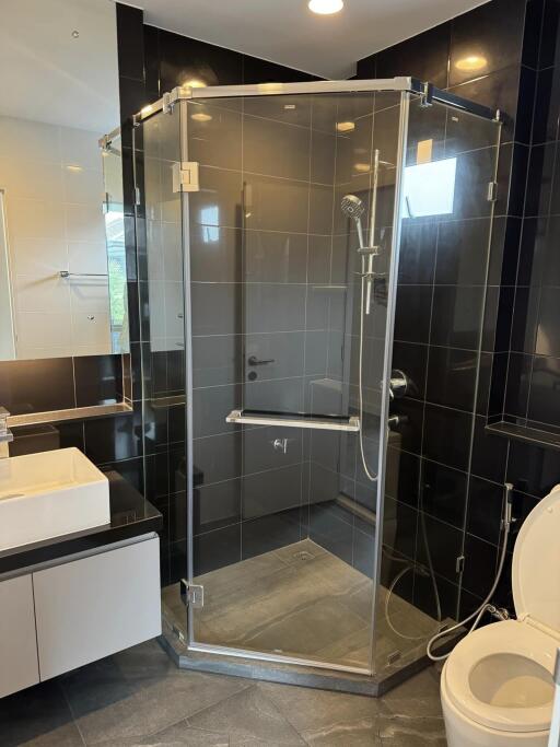 Modern bathroom with glass shower and white fixtures