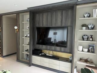 Modern living room with built-in TV and decorative shelves