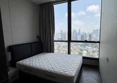 Bedroom with large window and city view