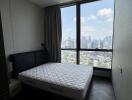 Bedroom with large window and city view