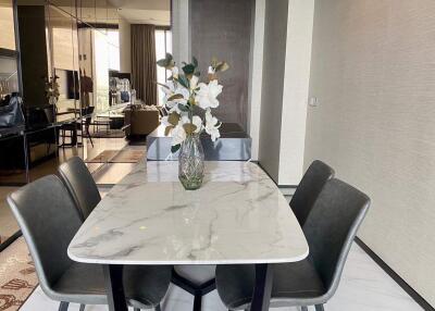 modern dining area with marble table and four chairs