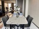 modern dining area with marble table and four chairs