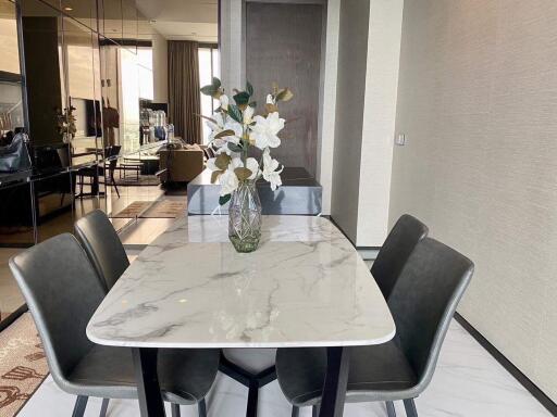 modern dining area with marble table and four chairs