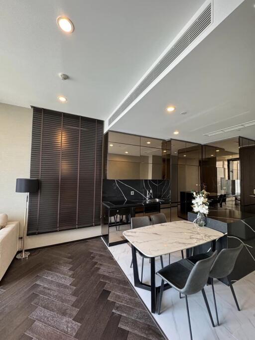 Modern living and dining area with stylish furniture and lighting