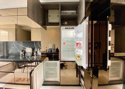 Modern kitchen with open fridge and sleek design