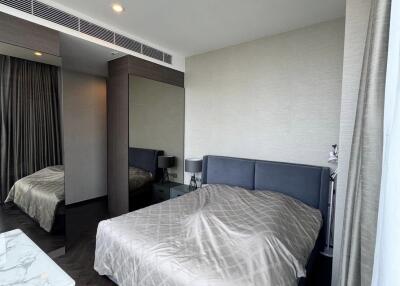 Modern bedroom with bed and mirrored wardrobe