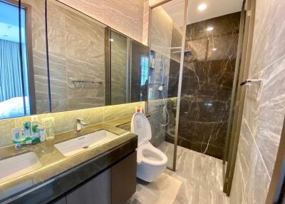 Modern bathroom with shower, toilet, and double sink