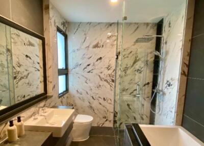 Modern bathroom with marble tiling and glass shower