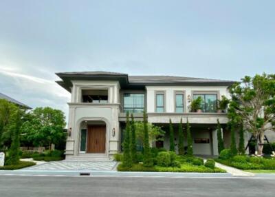 Front view of a modern two-story house with a well-maintained garden