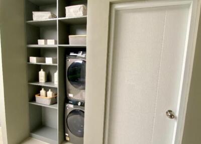 Modern laundry room with stacked washer and dryer