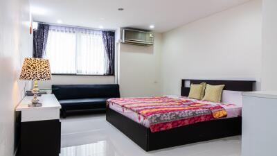 Modern bedroom with double bed, sofa, and décor