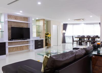 Spacious modern living room with TV and dining area