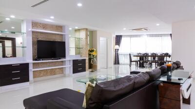 Spacious modern living room with TV and dining area