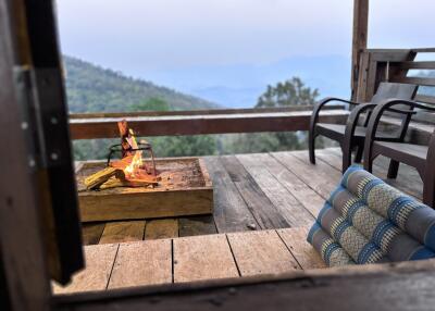 Outdoor patio with a fire pit and seating overlooking scenic mountain views