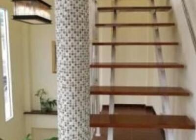 Wooden staircase with decorative column