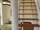 modern staircase with wooden steps and mosaic column