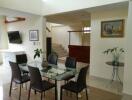 Modern dining room with glass table and black chairs