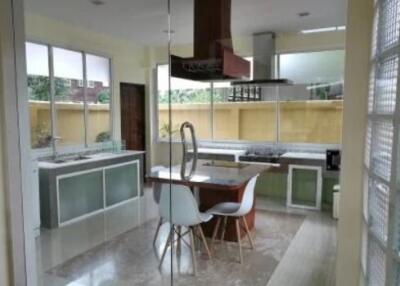 Modern kitchen with large windows and integrated dining area