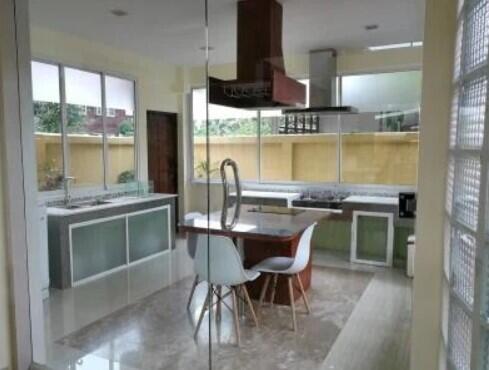 Modern kitchen with large windows and integrated dining area