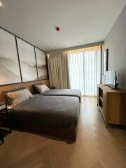 Modern bedroom with two beds and natural light