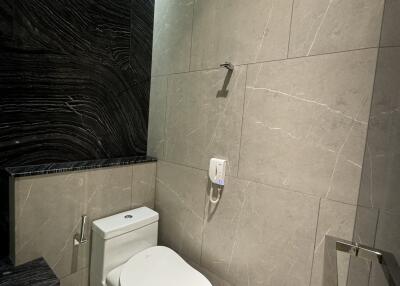 Modern bathroom with tiled walls and toilet