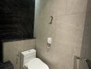 Modern bathroom with tiled walls and toilet