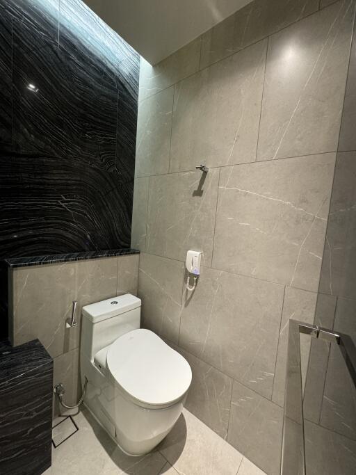 Modern bathroom with tiled walls and toilet