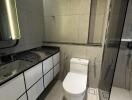 Modern bathroom with marble tiles and glass shower