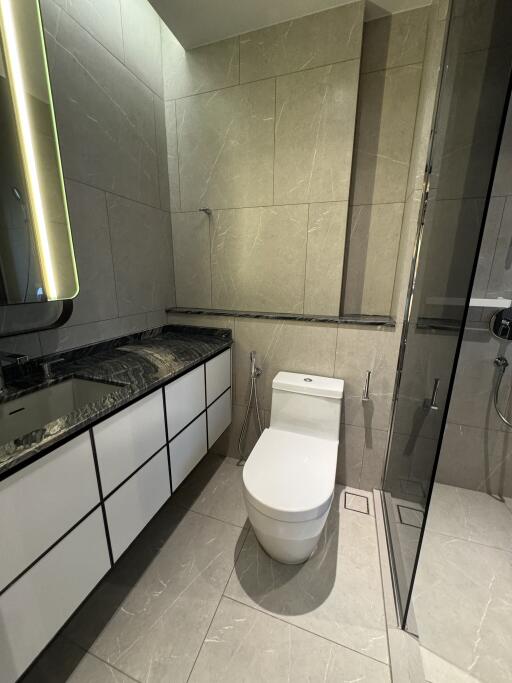 Modern bathroom with marble tiles and glass shower