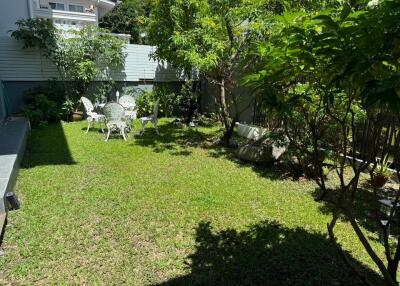 Beautiful garden with outdoor furniture and greenery