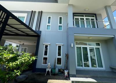 Modern two-story house exterior with large glass doors and windows