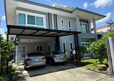 Front view of a modern two-story house with a driveway