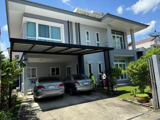 Front view of a modern two-story house with a driveway