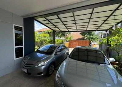 covered garage with two cars