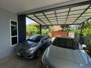 covered garage with two cars