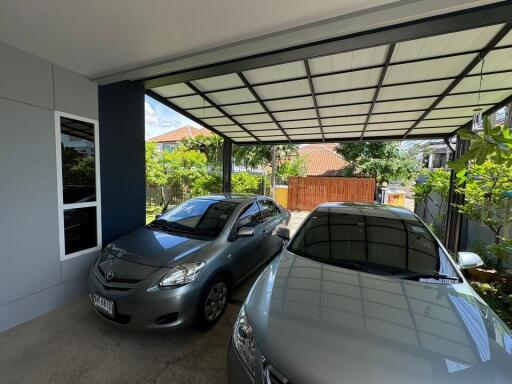 covered garage with two cars