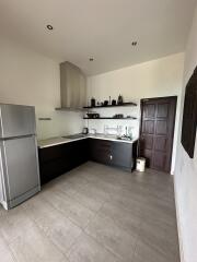 Modern kitchen with stainless steel appliances and dark cabinetry