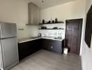 Modern kitchen with stainless steel appliances and dark cabinetry