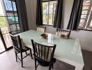 Dining table with chairs in a well-lit room