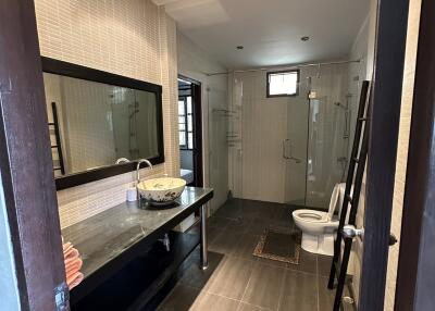 Modern bathroom with glass shower and large mirror