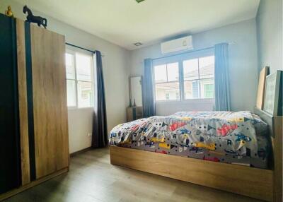 Modern bedroom with wood flooring and natural light