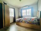 Modern bedroom with wood flooring and natural light